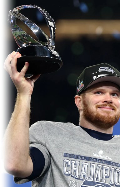 Seahawks quarterback with the NFC Championship trophy